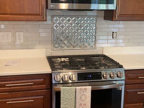 Kitchen range with custom tile backsplash. 